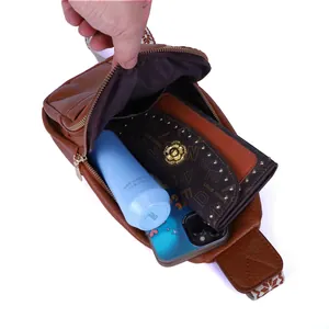 Detailed interior view of a vintage brown sling bag showing large storage capacity