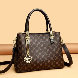 Elegant brown monogram print handbag featuring a stylish golden kangaroo charm for women