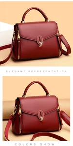 Elegant burgundy textured leather handbag featuring gold-tone hardware and top handle