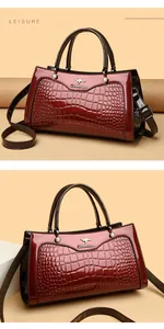 Close-up detail of vintage dark red crocodile pattern handbag with elegant top handles