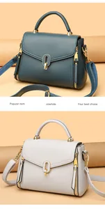 Elegant cowhide leather handbags in teal and white featuring a stylish golden oval clasp
