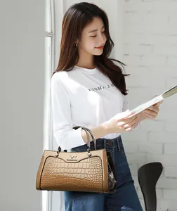 Elegant vintage crocodile pattern women's handbag with a glossy tan finish for a chic look