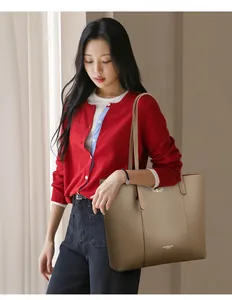 Professional Asian model carrying a large retro khaki leather tote bag for daily commute