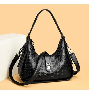 Detailed view of elegant black embossed underarm bag with silver twist-lock closure