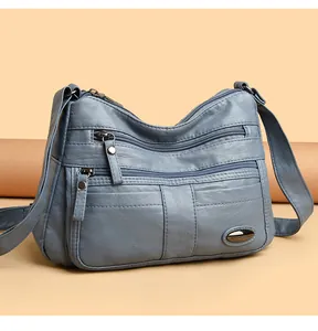 Stylish blue faux leather crossbody bag for women featuring a multi-pocket functional design