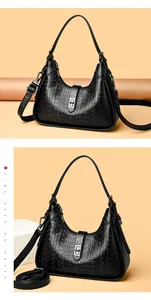 Detailed view of black embossed underarm bag with large capacity and shoulder strap