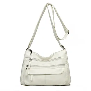 Sac bandoulière en cuir lavé blanc souple avec plusieurs poches zippées pour femmes