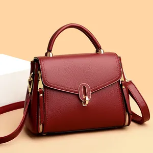 Elegant wine red leather handbag with gold hardware and top handle for women