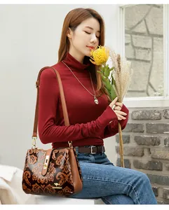 Elegant vintage embossed brown crossbody bag shown on an elegant model holding flowers