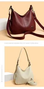 Detail view of large capacity faux leather hobo bags in burgundy and creamy white