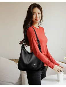 Elegant Asian woman carrying a large black lychee pattern leather shoulder bag hobo style