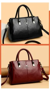 Vista detallada de elegantes bolsos de cuero negros y granates con asas trenzadas