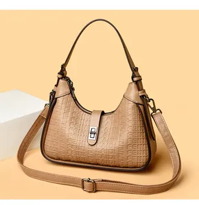 Detailed shot of the khaki hobo bag with embossed FEINI KAIDI logo and twist lock