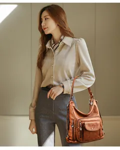 Brown vintage multi-functional women's shoulder bag worn by a model in a stylish setting