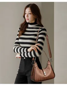 Detail view of a brown embossed underarm bag featuring a stylish textured finish.