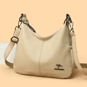 Elegant beige large capacity leather crossbody bag for women featuring a kangaroo logo