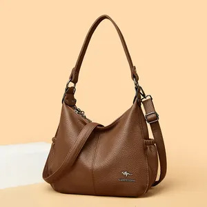 Brown pebbled leather hobo shoulder bag with adjustable crossbody strap for women.