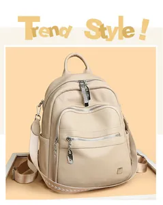 Detailed front view of a stylish cream soft leather backpack with silver zippers