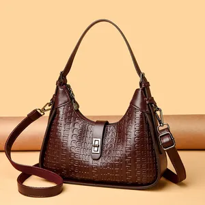 Elegant burgundy embossed leather underarm handbag with decorative gold turn-lock closure