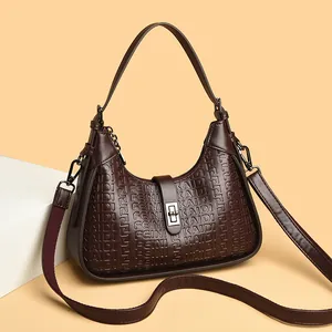 Elegant brown embossed hobo bag with top handle and adjustable shoulder strap.