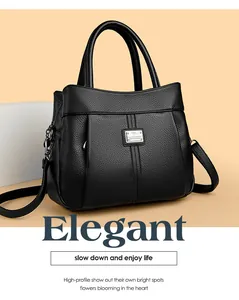 Elegant black textured leather handbag with top handles and adjustable shoulder strap