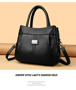 Professional macro shot of a black pebbled leather crossbody handbag in vintage style