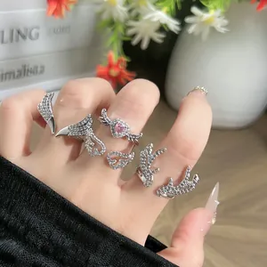 Detailed view of silver rings featuring antler and wing designs with sparkling crystals