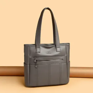 Bolso tote grande de cuero suave gris para mujer con elegante detalle de cremallera