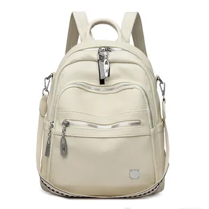 Large capacity beige soft leather women's backpack with multiple zippers and silver hardware