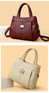 Vintage pebbled leather handbags in burgundy and beige featuring elegant top handles