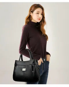 Elegant black textured leather handbag carried by a model for a stylish vintage look