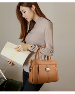 Elegant brown textured leather handbag held by model for vintage fashion style