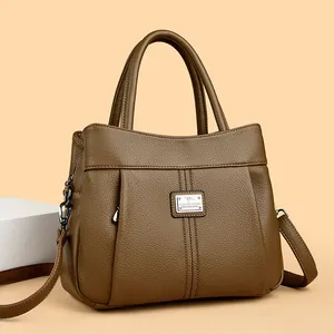 Fashionable brown textured leather women's handbag featuring a vintage top handle