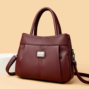 Elegant burgundy lychee pattern leather handbag with a silver metal kangaroo logo