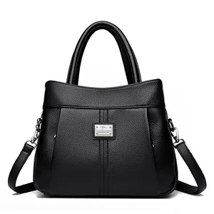 Elegant black lychee grain leather handbag featuring a detachable shoulder strap