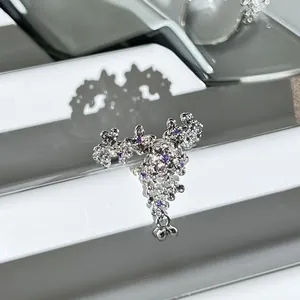 Macro detail of elegant silver open ring with purple crystal flowers and fringe design