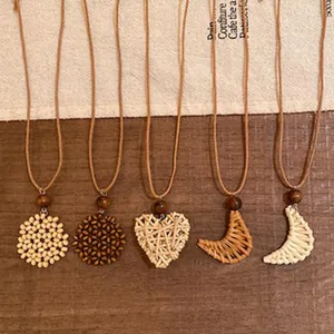 Detailed view of handmade woven necklaces with heart and moon pendants in boho style