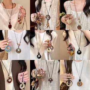 Detailed view of various vintage ethnic style long pendant necklaces on models