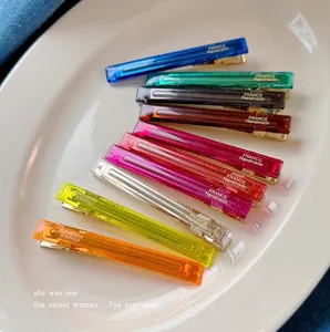 Close-up of colorful translucent acrylic hair clips with France Handmade text engraving