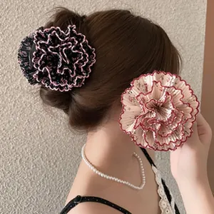 Side view showing the detailed ruffled texture of elegant floral hair claw clips on a model