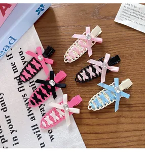 Assorted balletcore ribbon bow hair clips with gemstone accents on wood surface.