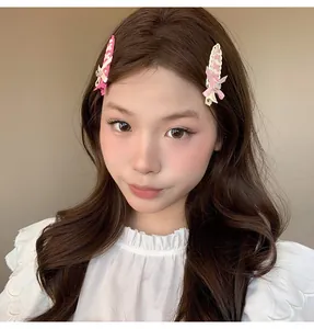 Close-up detail of balletcore ribbon woven hair clips with bow on a female model
