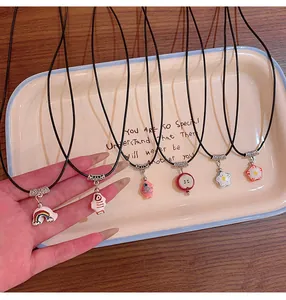Colorful dopamine necklaces with flower and rainbow pendants displayed on a tray