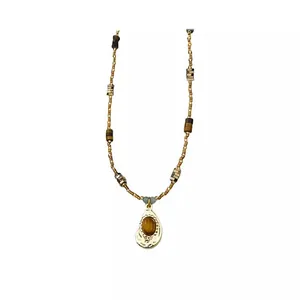 Vintage brown tiger eye beaded sweater necklace with a golden teardrop pendant