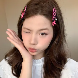 Sweet ballet style pink and black ribbon woven hair clips worn by a young female model