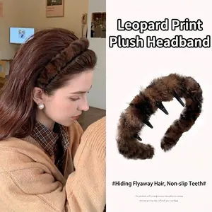 Detail of a brown leopard print plush headband with non-slip teeth for hair styling.