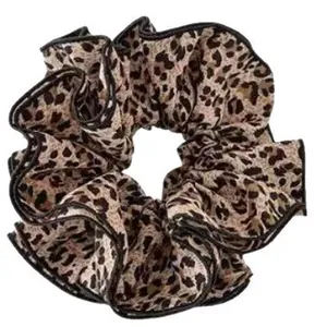 Vintage leopard print fabric scrunchie hair tie with black trim for ponytail styles