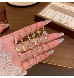 Detailed macro view of gold-plated bracelets with sparkling zircons and cat's eye stones