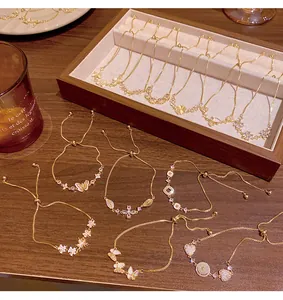 Detailed view of luxury gold-plated zirconia and cat's eye stone adjustable bracelets