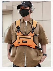 Detailansicht einer orangefarbenen taktischen Brusttasche an einem Model im Freien
